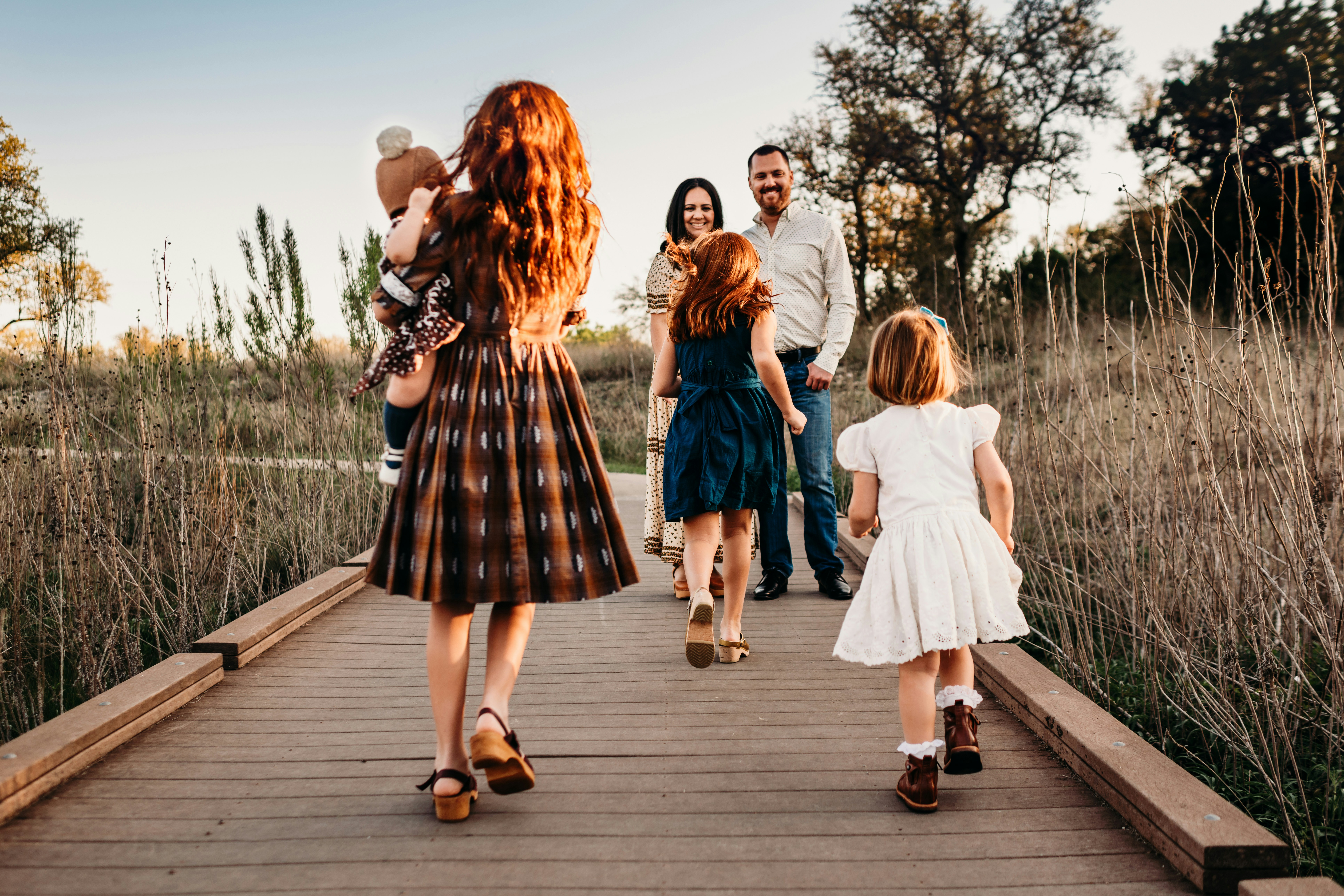 family walking over a bridge