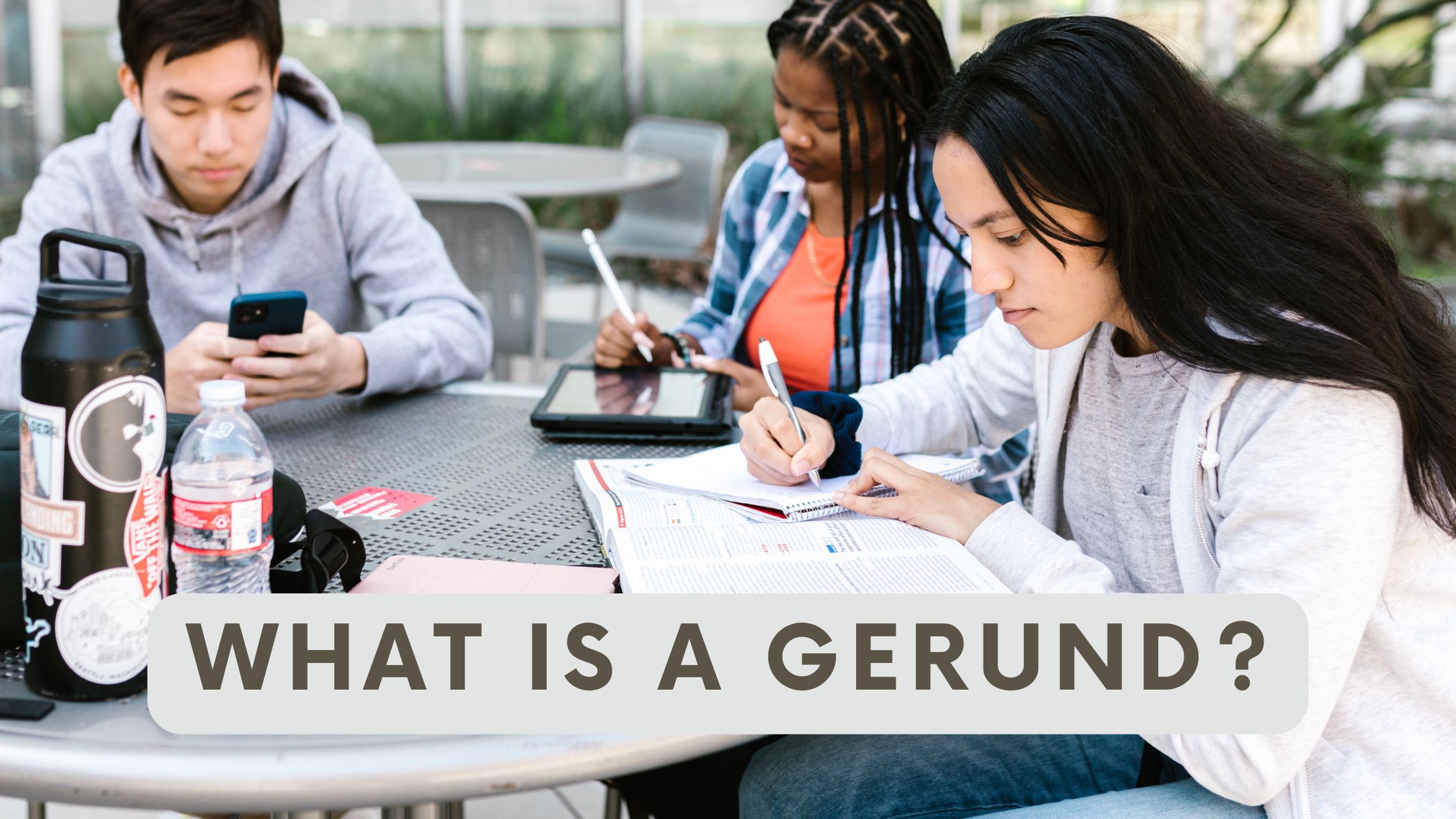 three friends studying english and practising gerunds