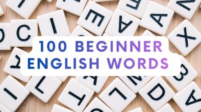 scrabble letters with 100 beginner english words written in front of them